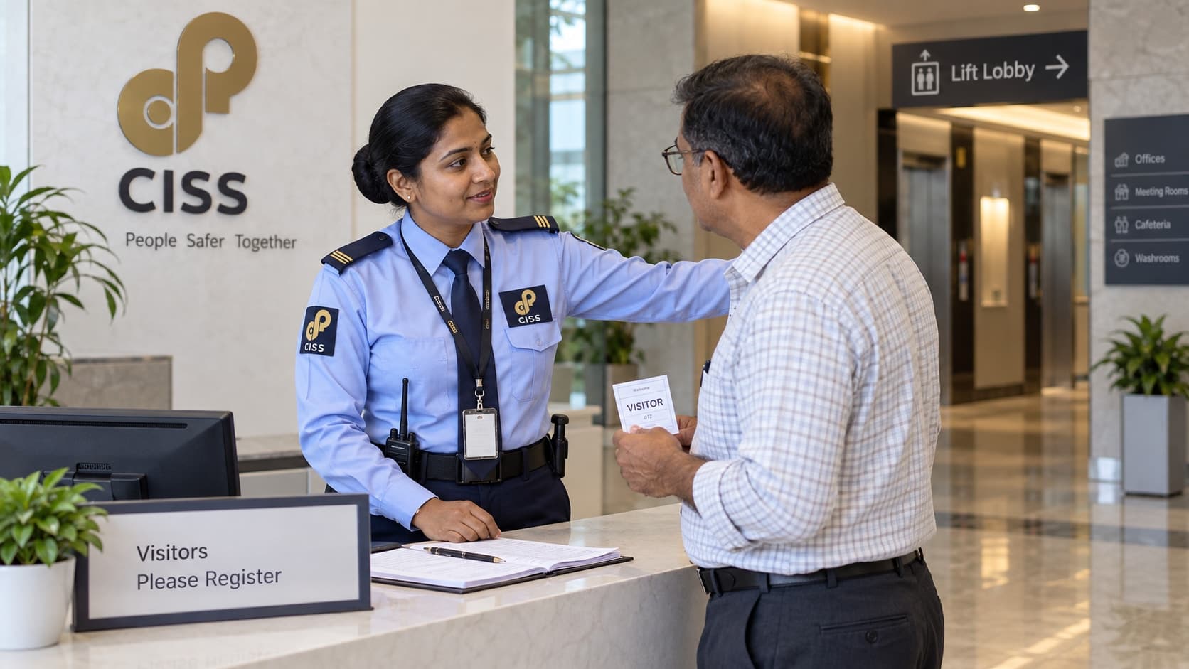 An Indian CISS security guard helping a visitor find the lift lobby