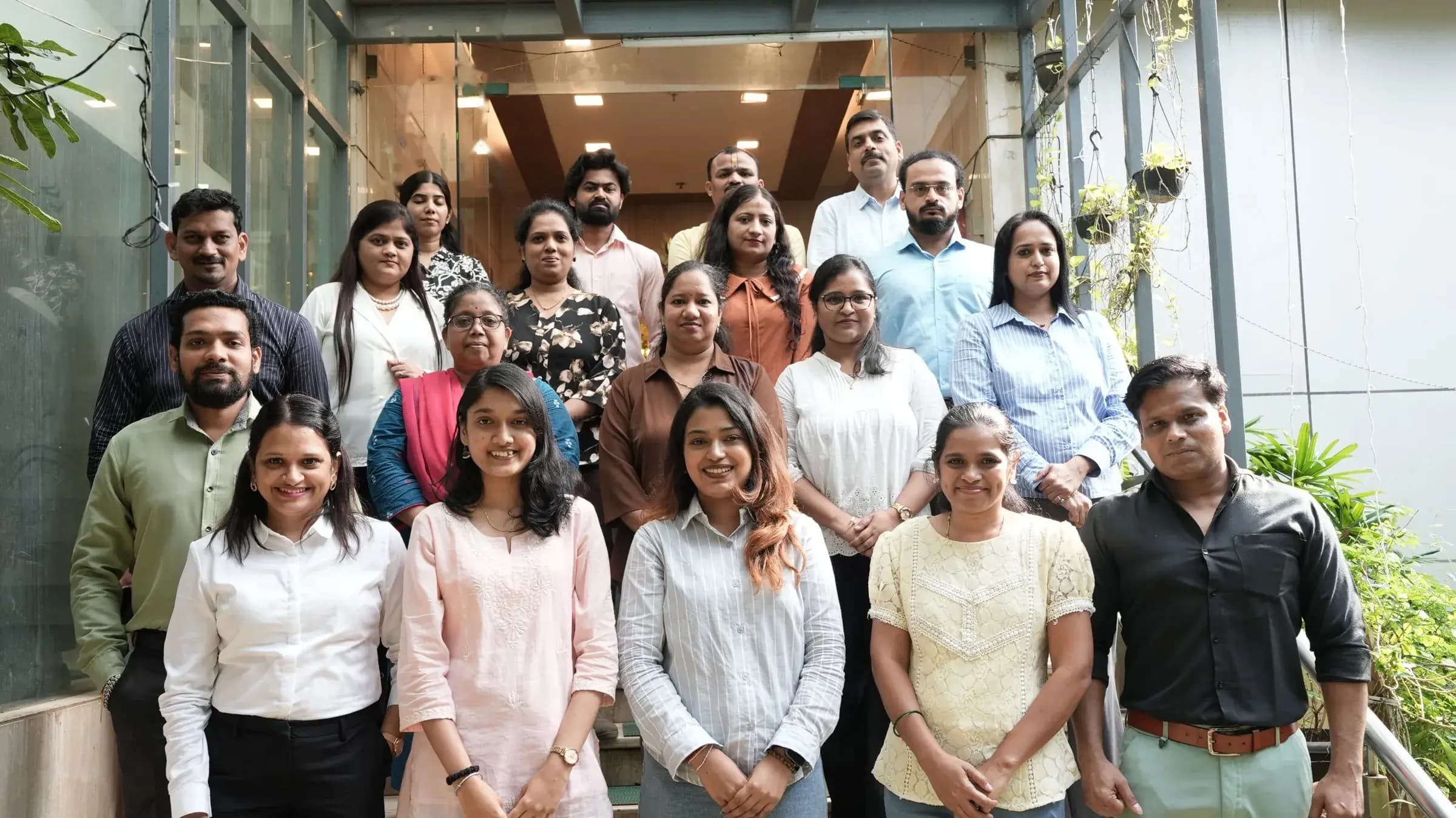 The CISS corporate office team gathered on the steps outside the Mukti Foundation Building, Andheri (West), Mumbai