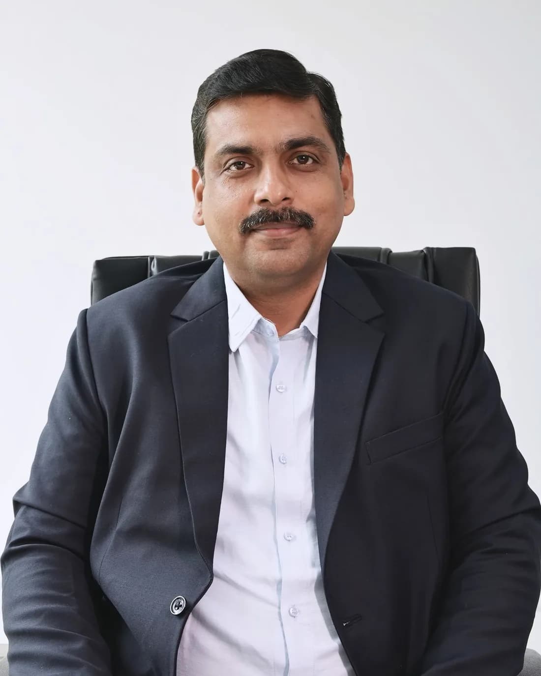 Mr. Sachin Choudhary, Vice President (Large Client Group), seated at his desk
